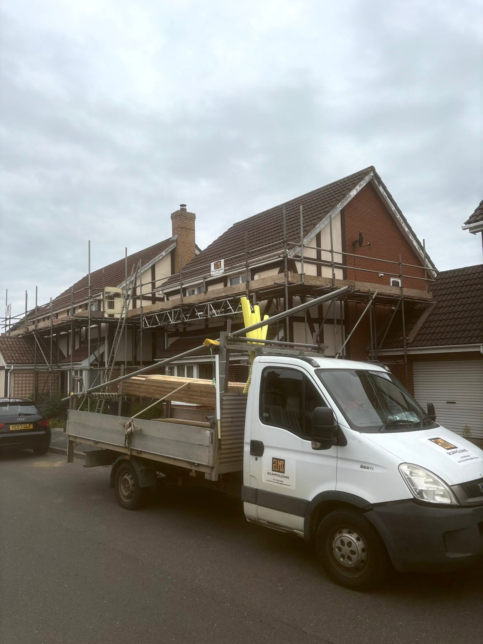 Elms Scaffolding van on site in front of a scaffolded property